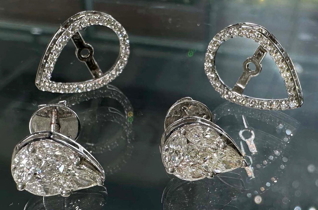 Close-up of elegant 10K white gold halo jacket earrings featuring an illusion pear-shaped centerpiece made from small marquise and pear-shaped lab-grown diamonds, totaling 1.62 carats, set in a pavé setting that enhances the sparkle and illusion of a single large pear-shaped diamond.