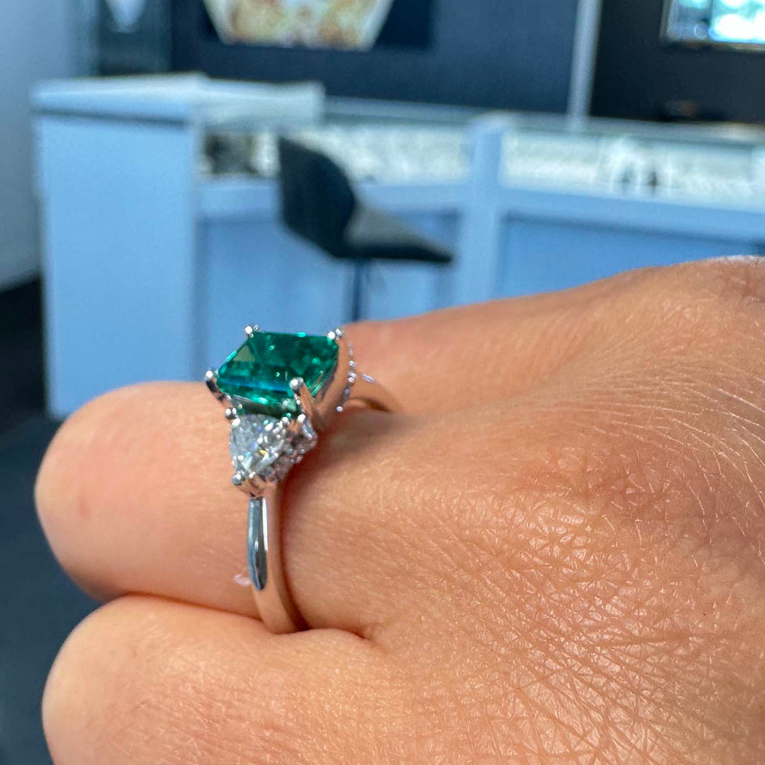 Lab-grown emerald ring with moissanite accents set in 14K white gold.