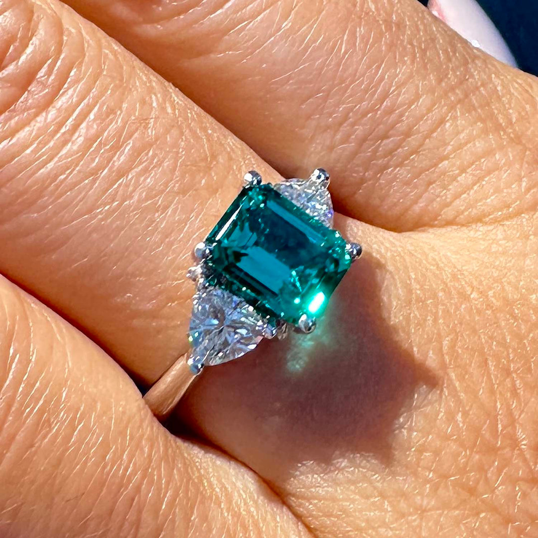 Lab-grown emerald ring with moissanite accents set in 14K white gold.