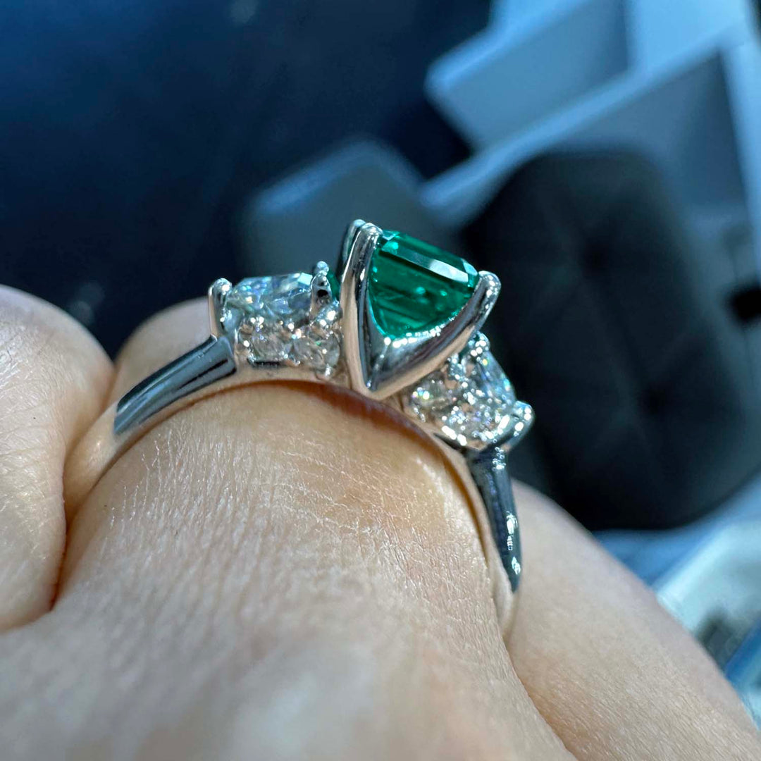 Lab-grown emerald ring with moissanite accents set in 14K white gold.