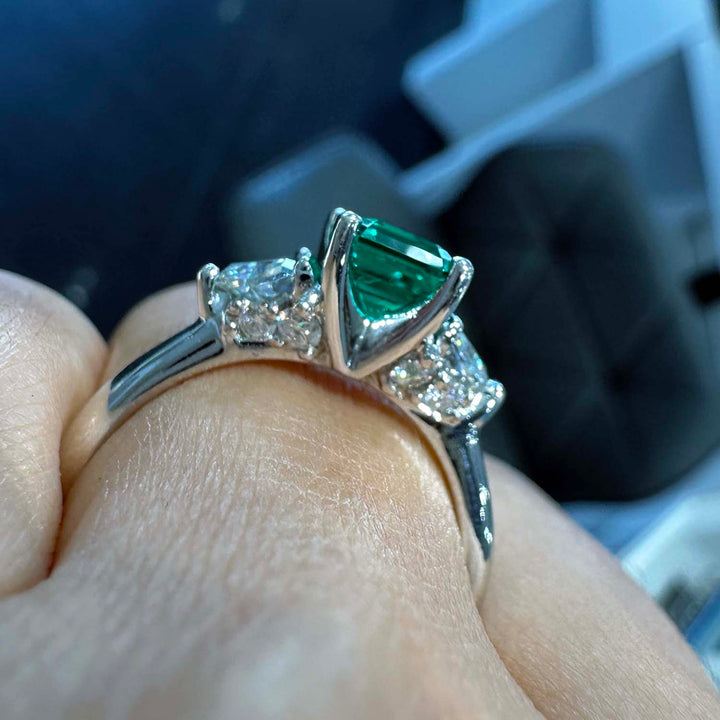 Lab-grown emerald ring with moissanite accents set in 14K white gold.