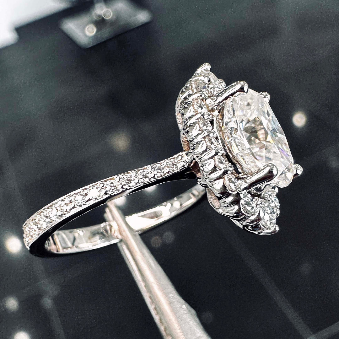 2CT oval moissanite halo engagement ring with pavé band in 14K gold.