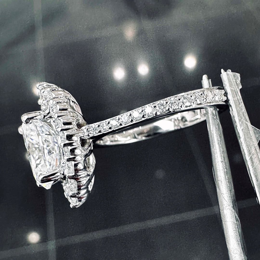 2CT oval moissanite halo engagement ring with pavé band in 14K gold.