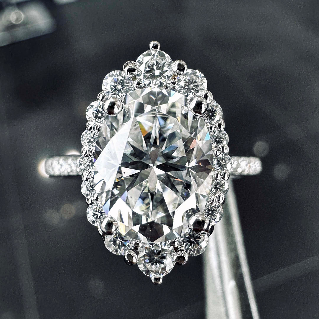 2CT oval moissanite halo engagement ring with pavé band in 14K gold.