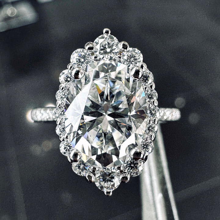 2CT oval moissanite halo engagement ring with pavé band in 14K gold.