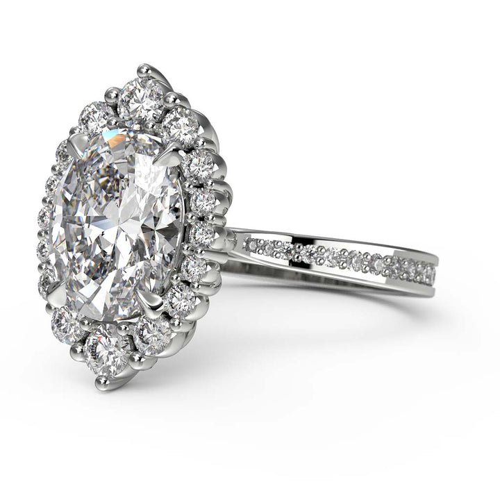 2CT oval moissanite halo engagement ring with pavé band in 14K gold.
