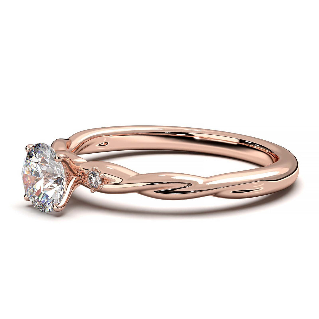 Twisted solitaire engagement ring with a large center diamond and two smaller side diamonds.