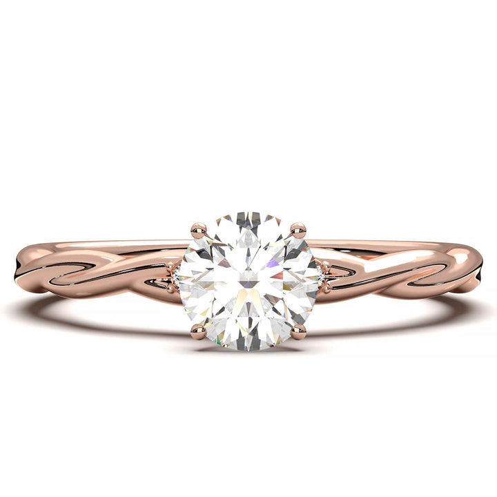 Twisted solitaire engagement ring with a large center diamond and two smaller side diamonds.