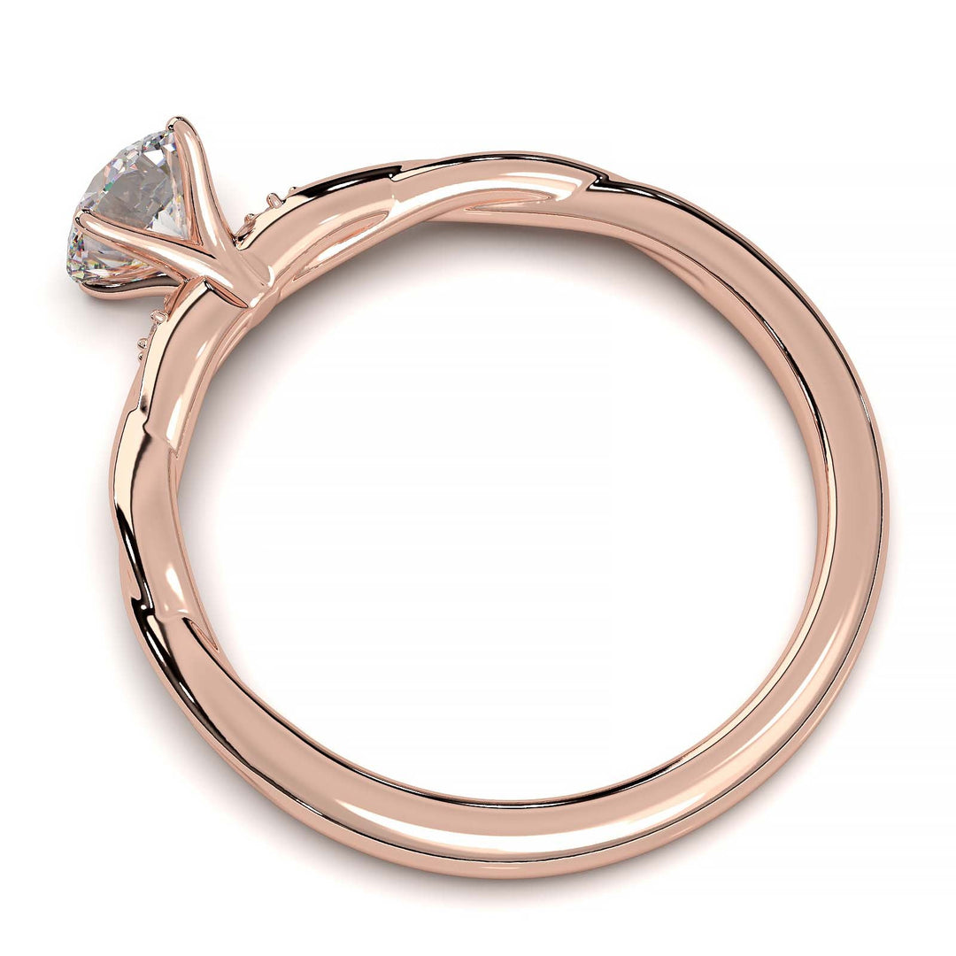 Twisted solitaire engagement ring with a large center diamond and two smaller side diamonds.