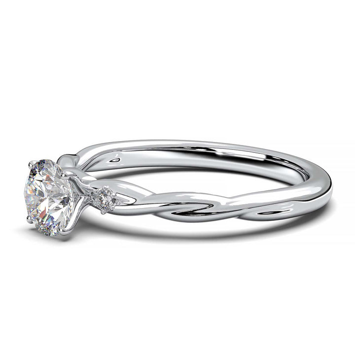 Twisted solitaire engagement ring with a large center diamond and two smaller side diamonds.