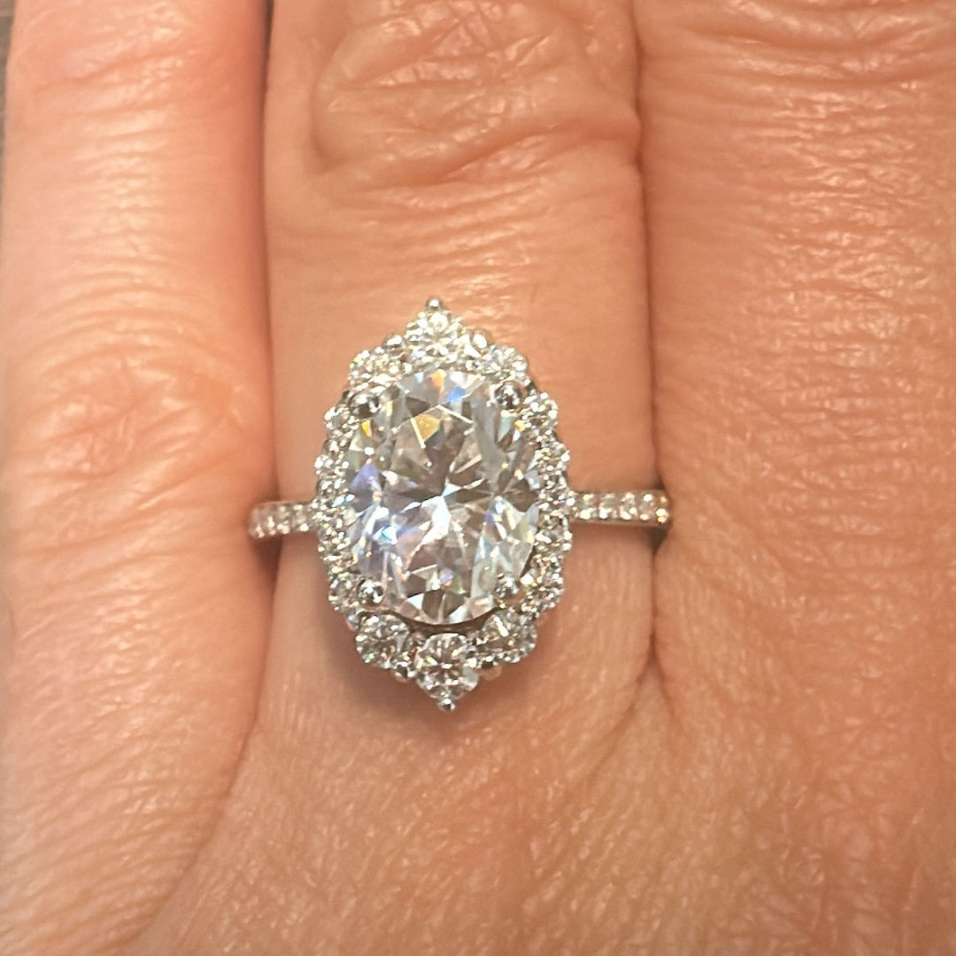 2CT oval moissanite halo engagement ring with pavé band in 14K gold.