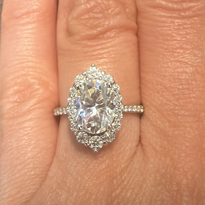 2CT oval moissanite halo engagement ring with pavé band in 14K gold.