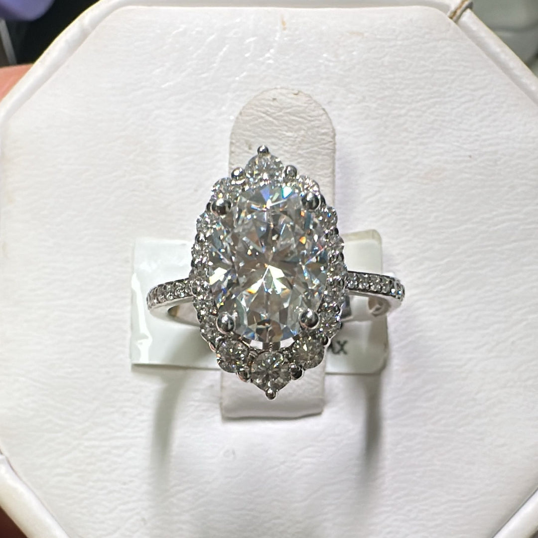 2CT oval moissanite halo engagement ring with pavé band in 14K gold.