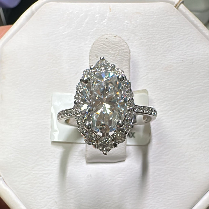 2CT oval moissanite halo engagement ring with pavé band in 14K gold.