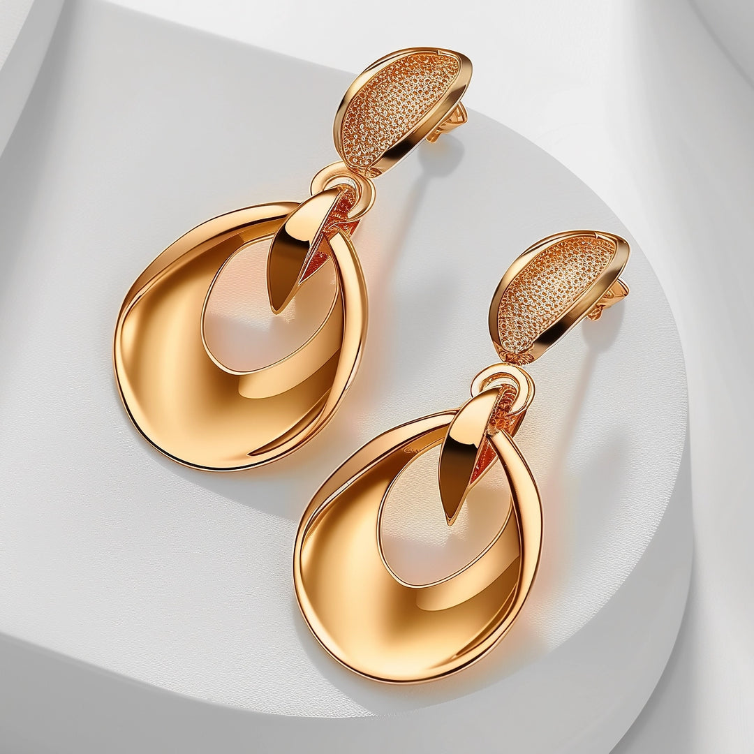 Gold drop earrings featuring double loop design with textured and polished finishes, luxurious fashion accessory on a white background.