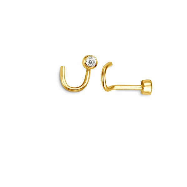A close-up image of a pair of gold nose rings with a unique curved design. Rings feature a small, clear gemstone set in a bezel setting, adding a touch of sparkle.