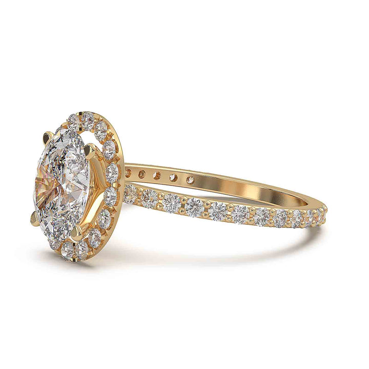 Oval diamond halo engagement ring with pavé diamond band and custom prong setting.
