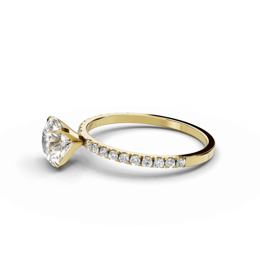 Round diamond pavé engagement ring in yellow gold.