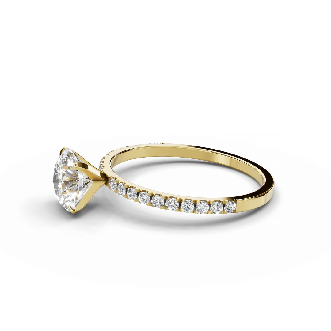 Round diamond pavé engagement ring in yellow gold.