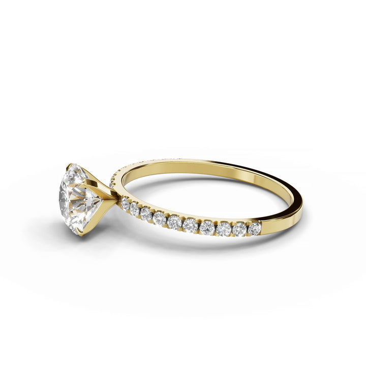 Round diamond pavé engagement ring in yellow gold.