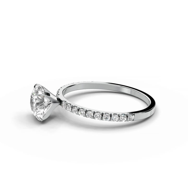Round diamond pavé engagement ring in white gold.