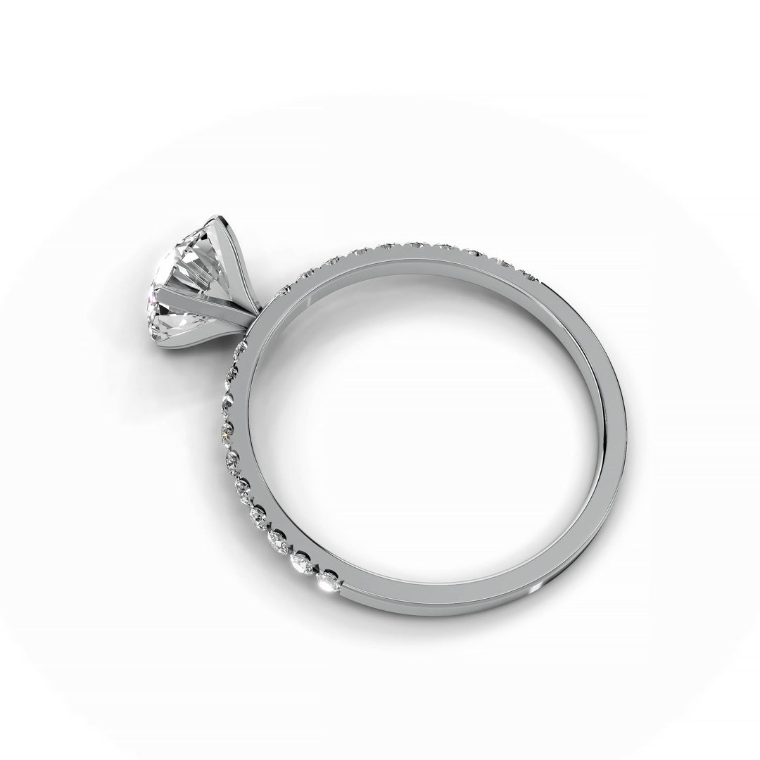 Round diamond pavé engagement ring in white gold.