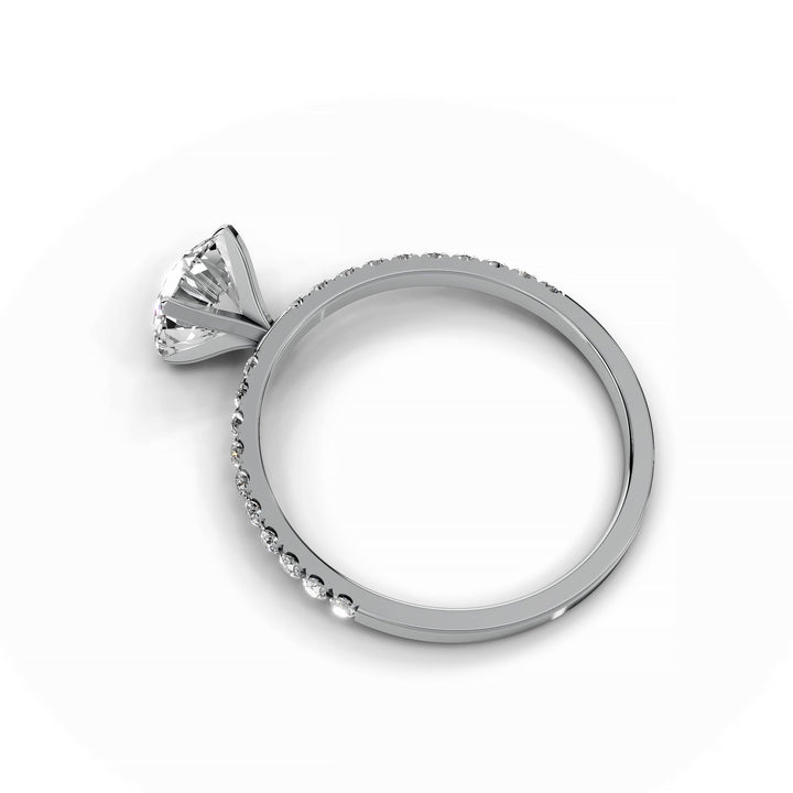 Round diamond pavé engagement ring in white gold.