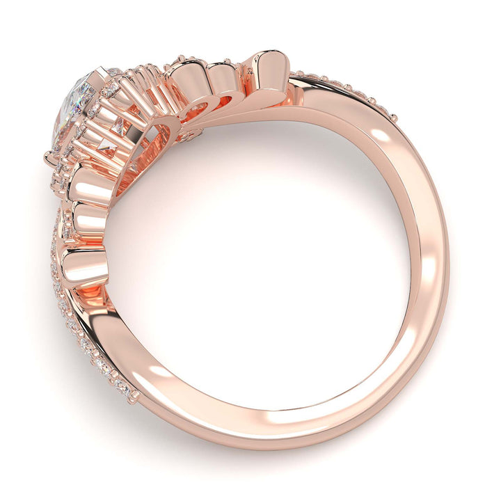 Pear-shaped diamond vintage engagement ring with custom prongs and halo design.