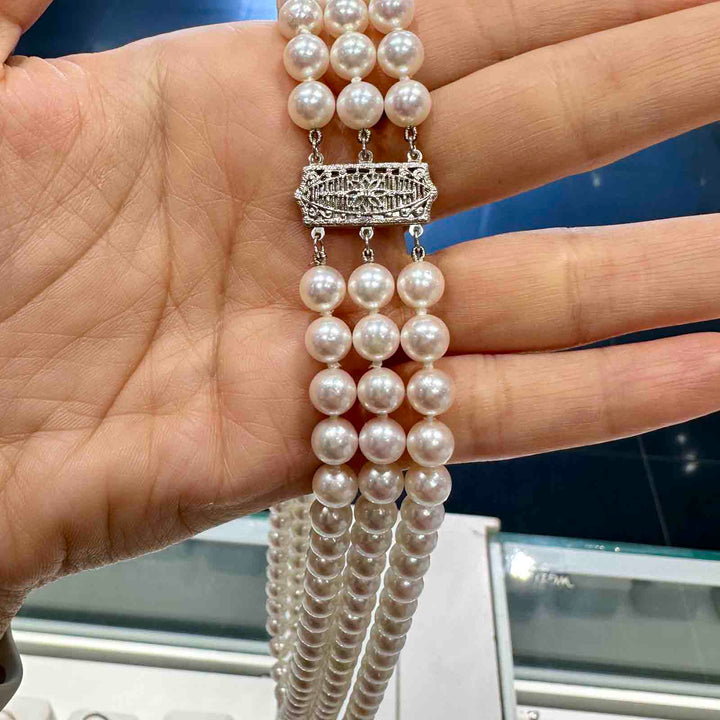 Three-strand Akoya cultured pearl necklace with 6.9-6.5mm AAA quality pearls and 14k clasp.