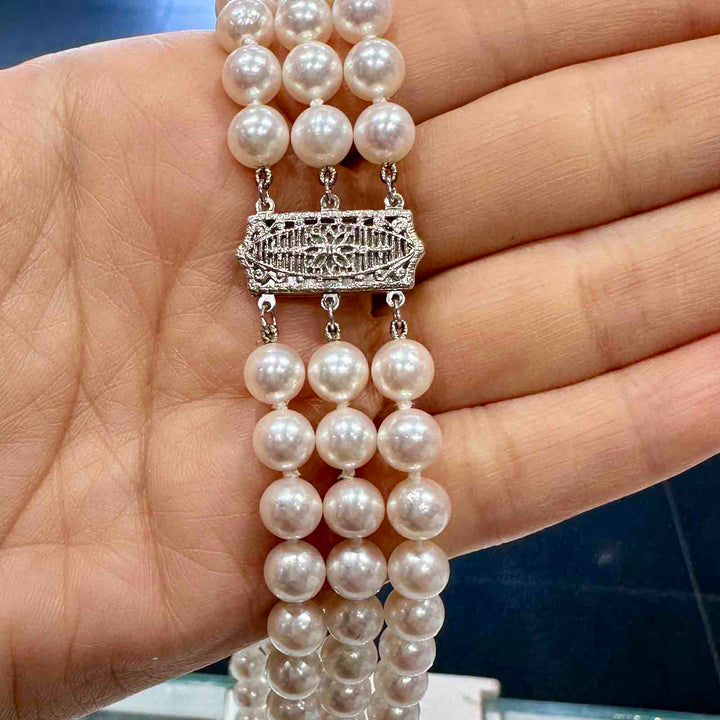 Three-strand Akoya cultured pearl necklace with 6.9-6.5mm AAA quality pearls and 14k clasp.