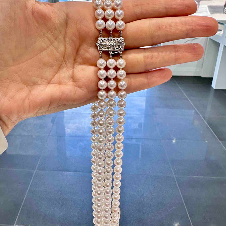 Three-strand Akoya cultured pearl necklace with 6.9-6.5mm AAA quality pearls and 14k clasp.