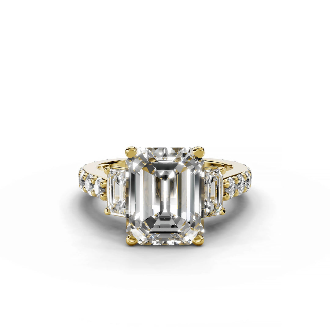 Emerald cut diamond three-stone engagement ring in yellow gold.