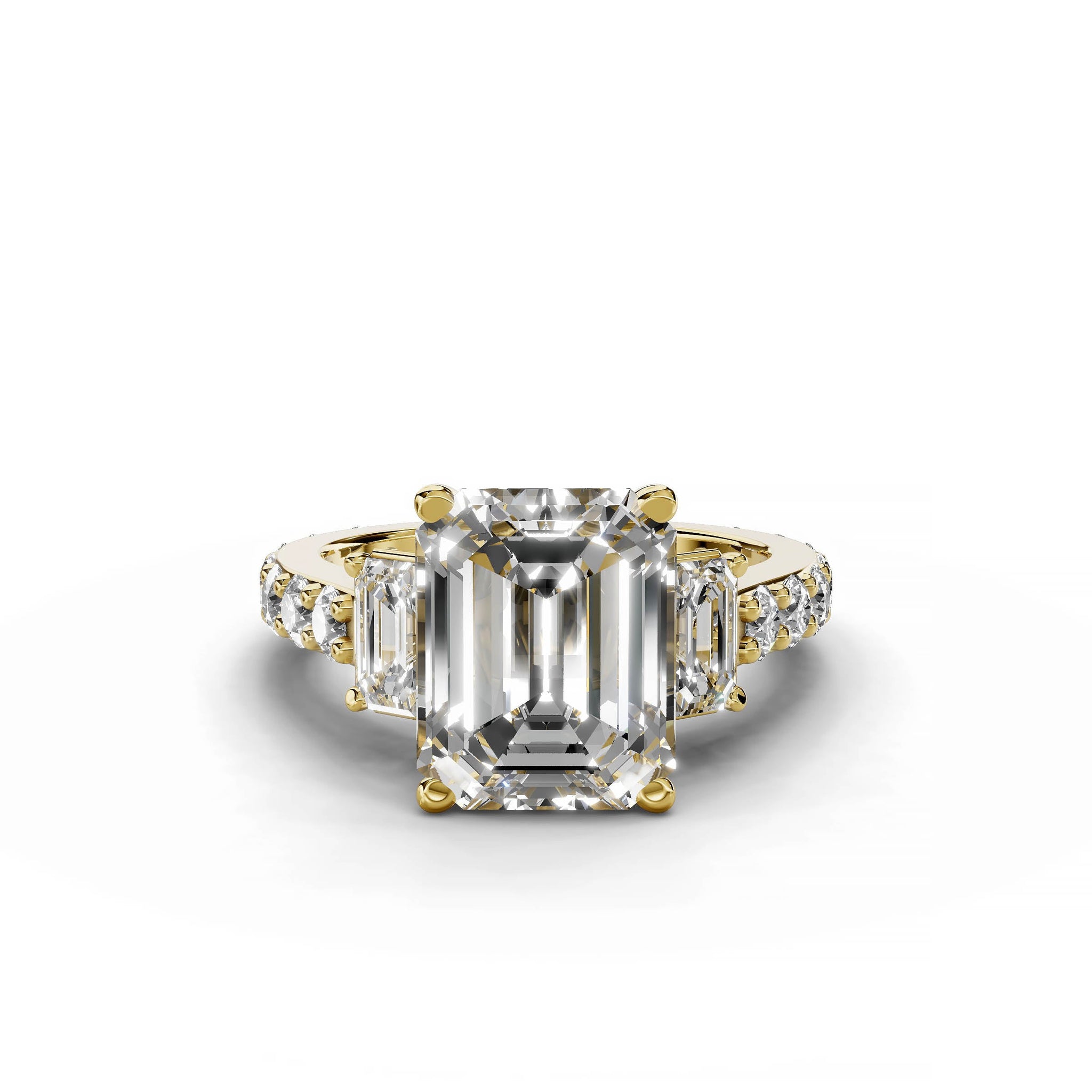 Emerald cut diamond three-stone engagement ring in yellow gold.