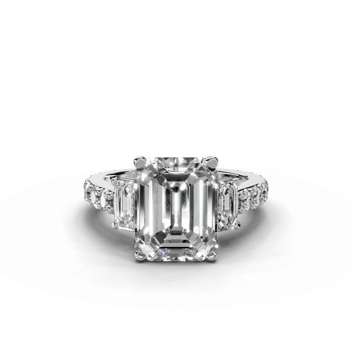 Emerald cut diamond three-stone engagement ring in white gold.