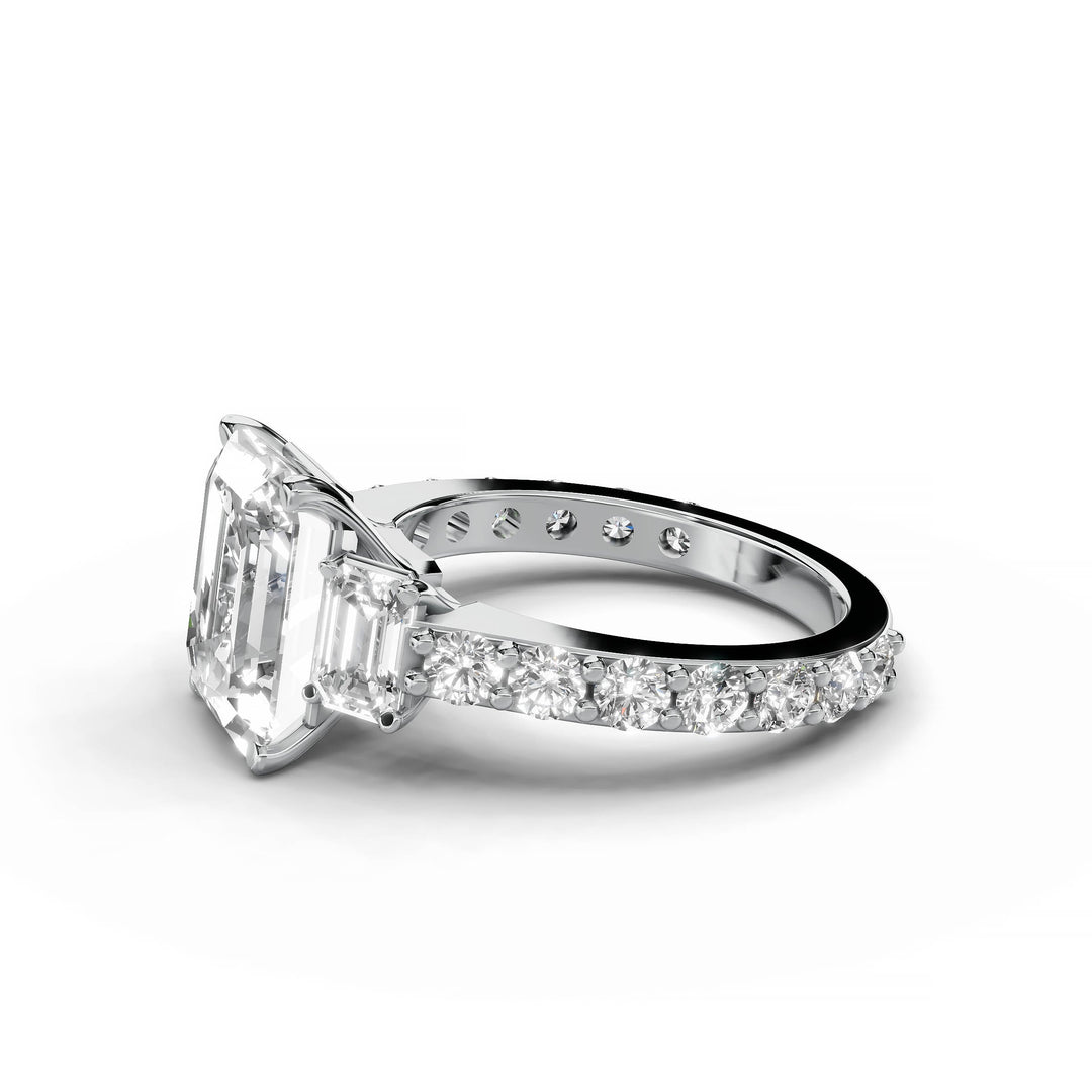 Emerald cut diamond three-stone engagement ring in white gold.