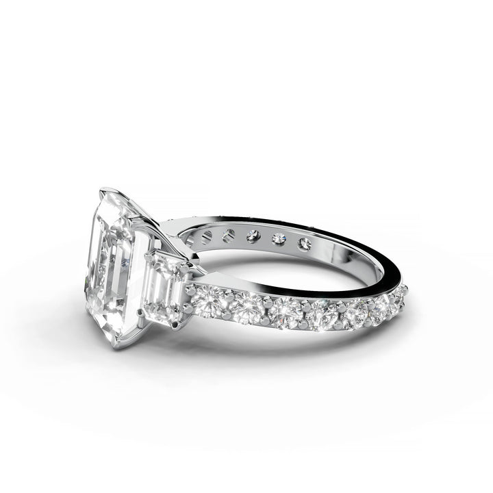 Emerald cut diamond three-stone engagement ring in white gold.