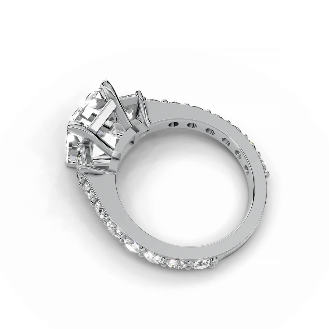 Emerald cut diamond three-stone engagement ring in white gold.