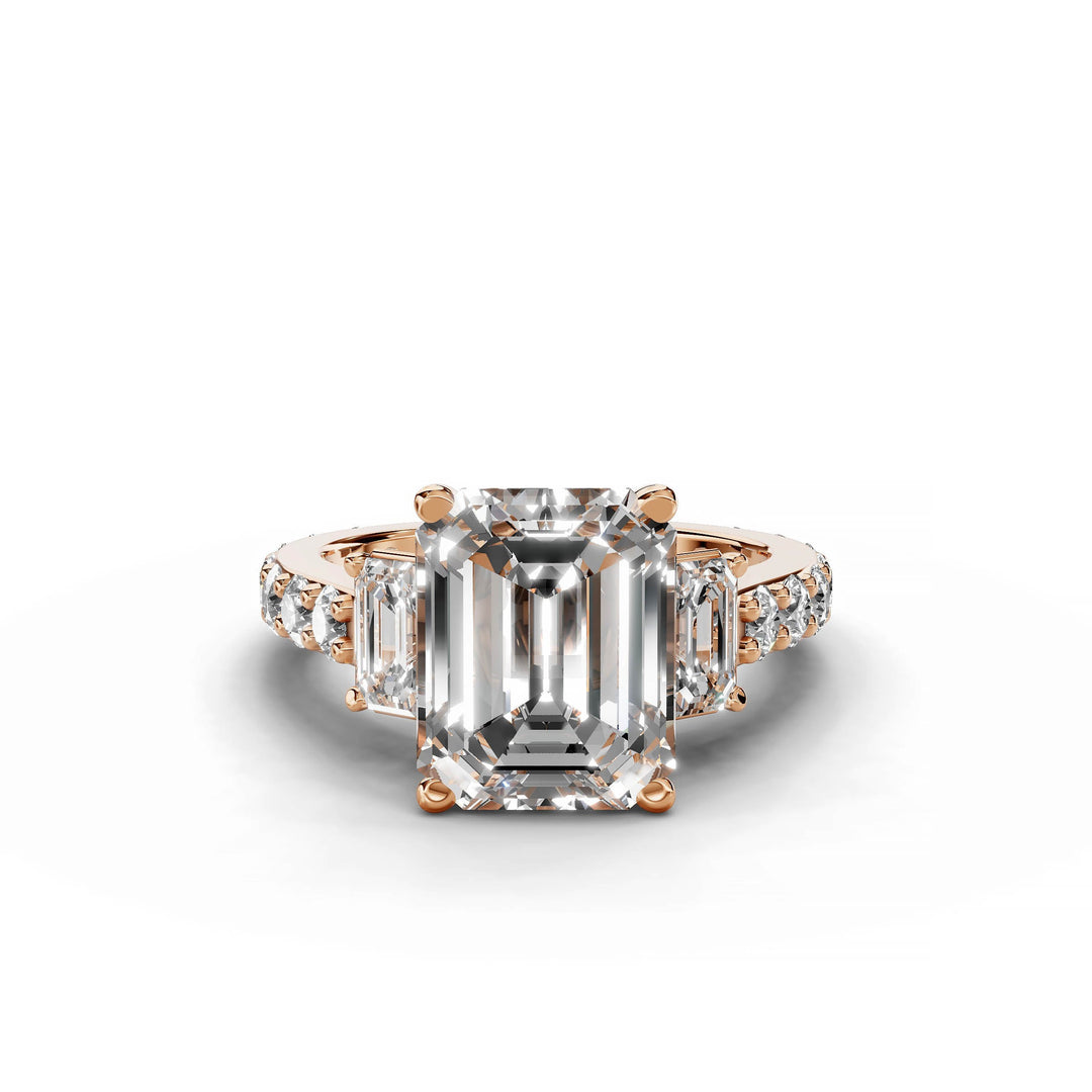 Emerald cut diamond engagement ring with three stones in rose gold.
