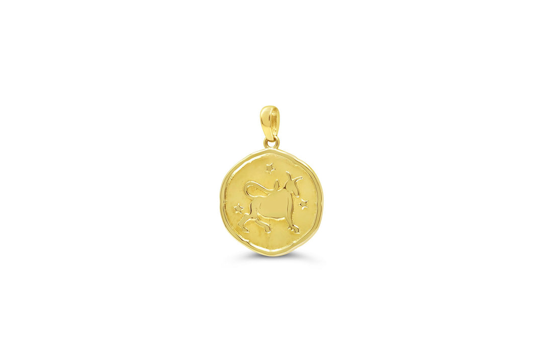 10K yellow gold Taurus zodiac pendant with bull engraving and star accents in a polished round medallion design.