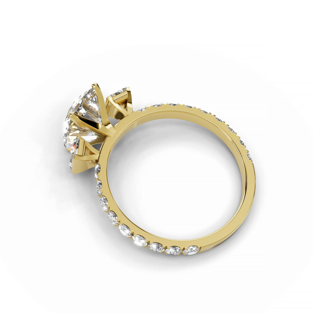 Cushion cut diamond engagement ring with baguette and round diamonds in yellow gold.