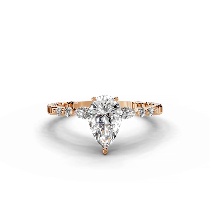Pear-shaped diamond engagement ring, three-stone style, rose gold band.