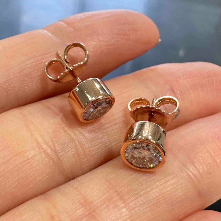 10K rose gold stud earrings with 6mm high-quality moissanite stones and strong butterfly backings, custom-made design.