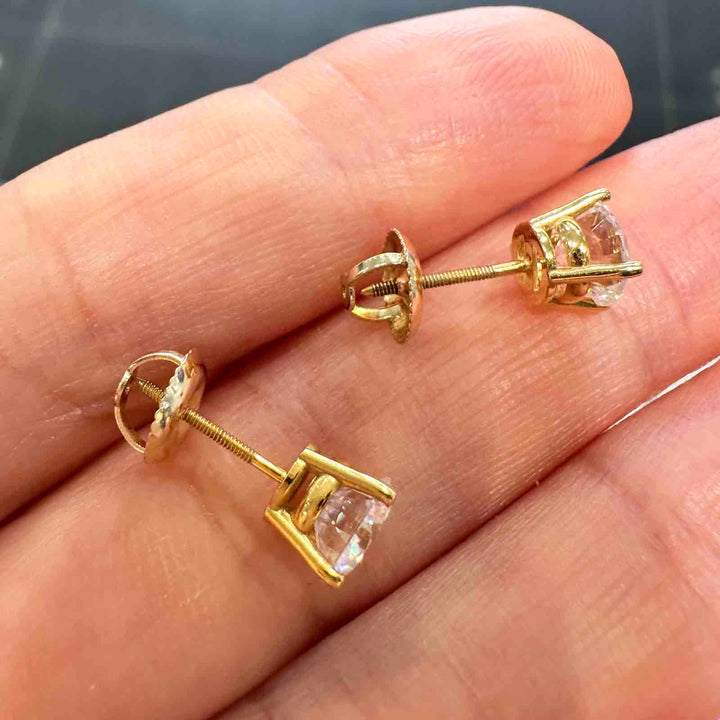 14K yellow gold stud earrings with 6mm colorless moissanite stones and secure screw-back closures, simple and elegant design.