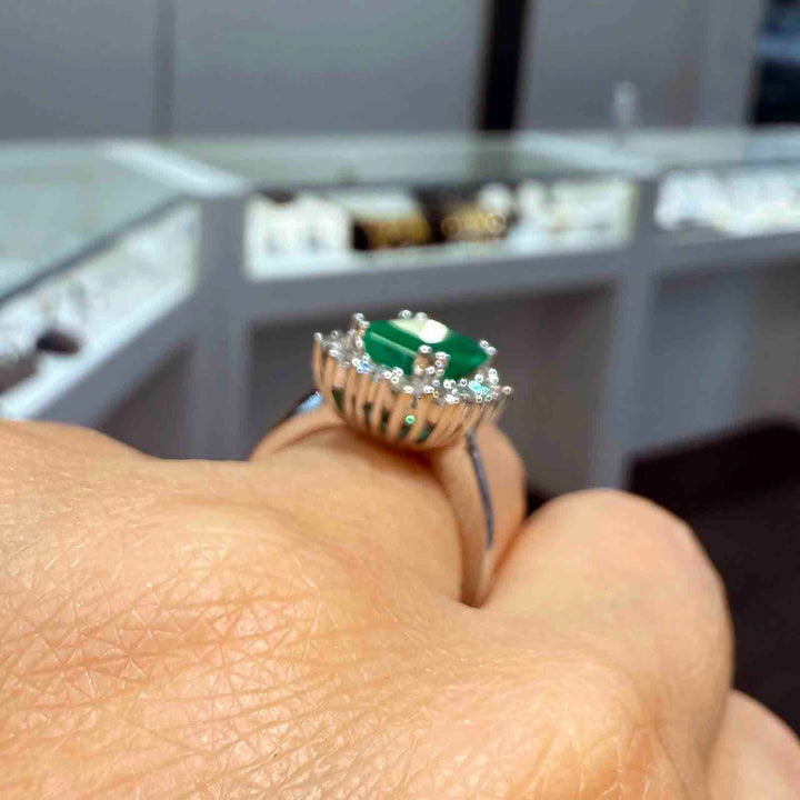 1.25 CT Colombian emerald ring with 0.58 CT diamonds in 14K white gold.