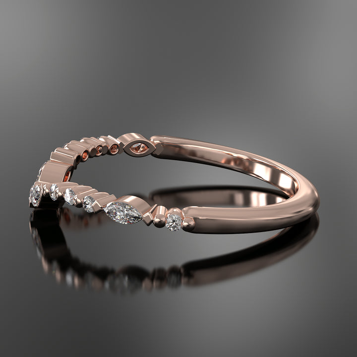 Curved wedding band with marquise and round lab-grown diamonds in a floating design with shared prongs.