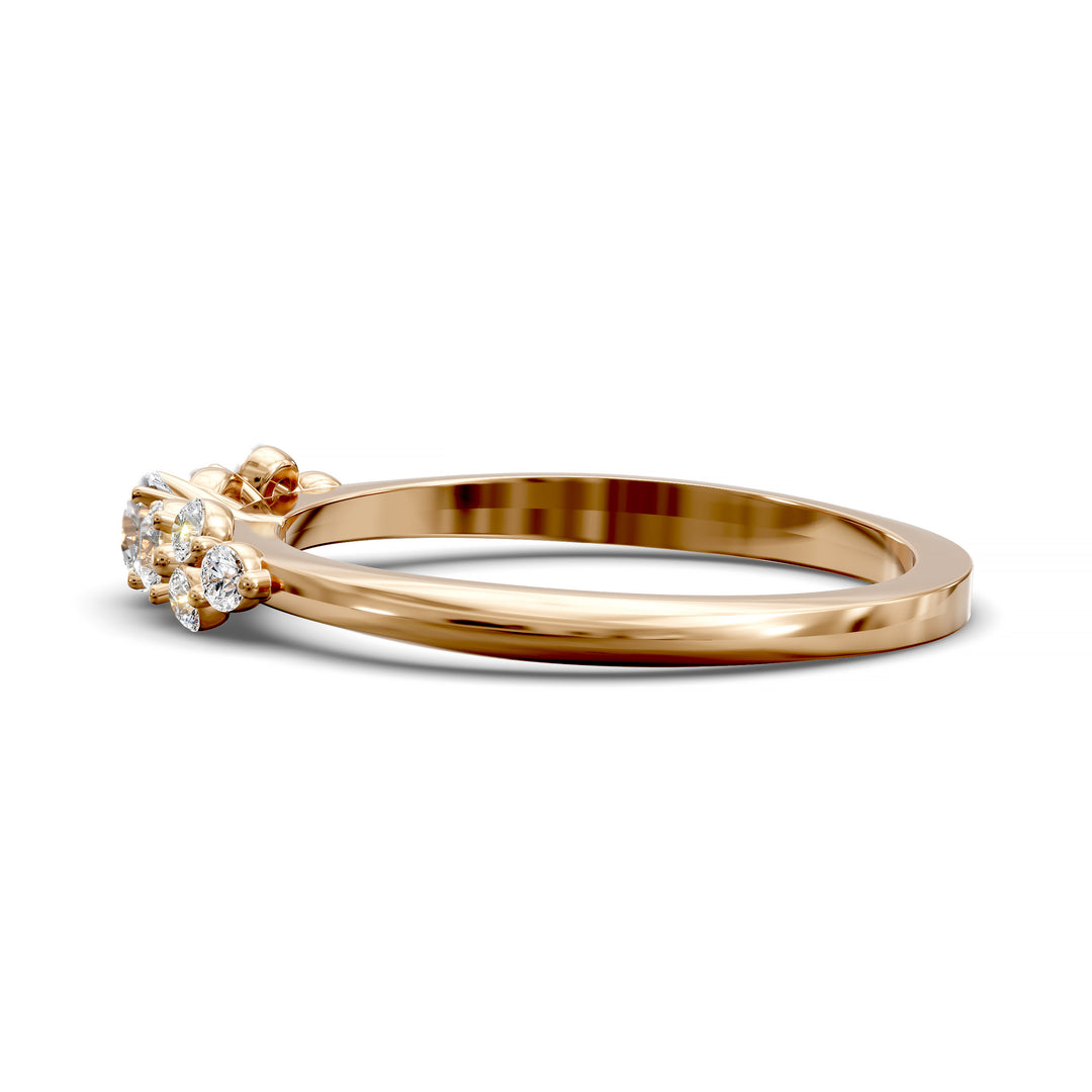 Dainty cluster diamond wedding band with floral-inspired design and tapered band