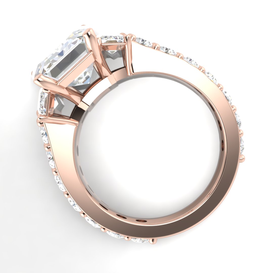 Emerald three stone engagement ring