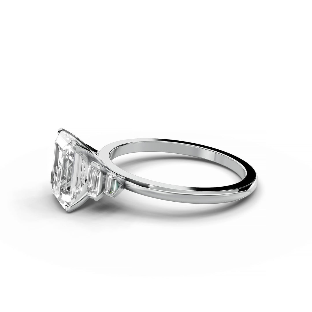 Emerald cut diamond five stone engagement ring in white gold.