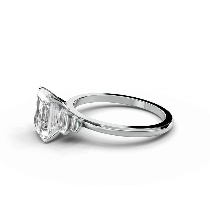 Emerald cut diamond five stone engagement ring in white gold.