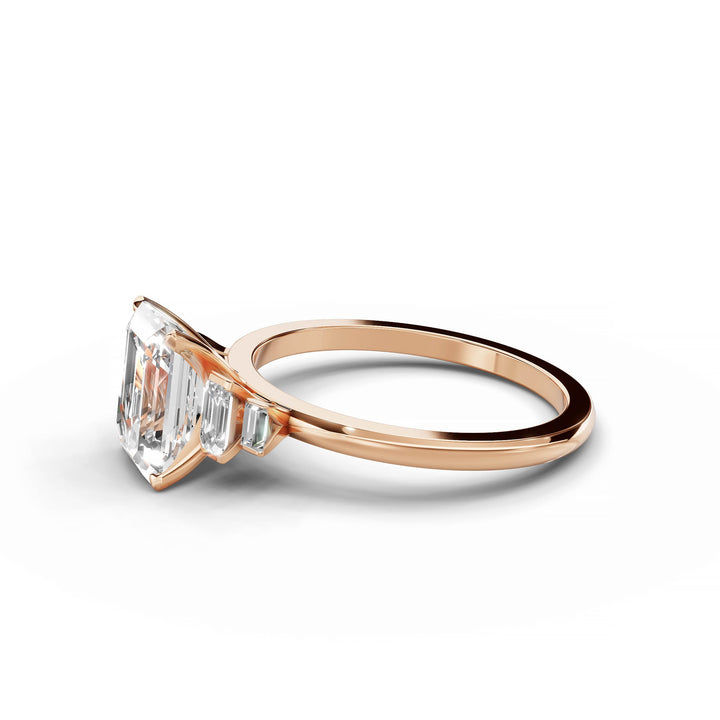 Emerald cut diamond five stone engagement ring in rose gold.